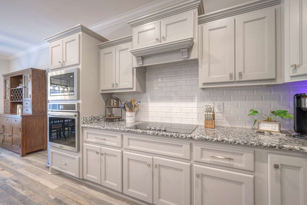 Beautiful counters, plenty of cabinets, and built in cooktop and stove help keep everything looking sharp and tidy.