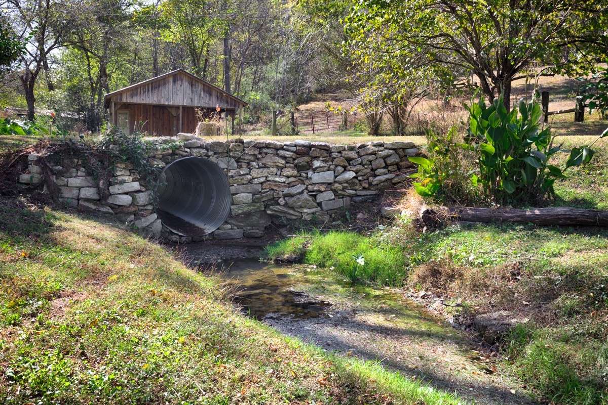 Hand laid rock driveway with culvert for drainage ditch