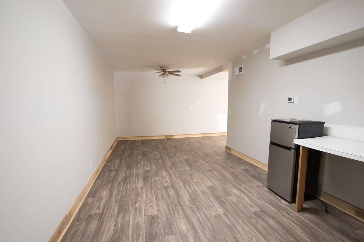 Basement finished apartment/mother-in-law suite. This is the kitchenette and living room area. Sink and cabinets as well.