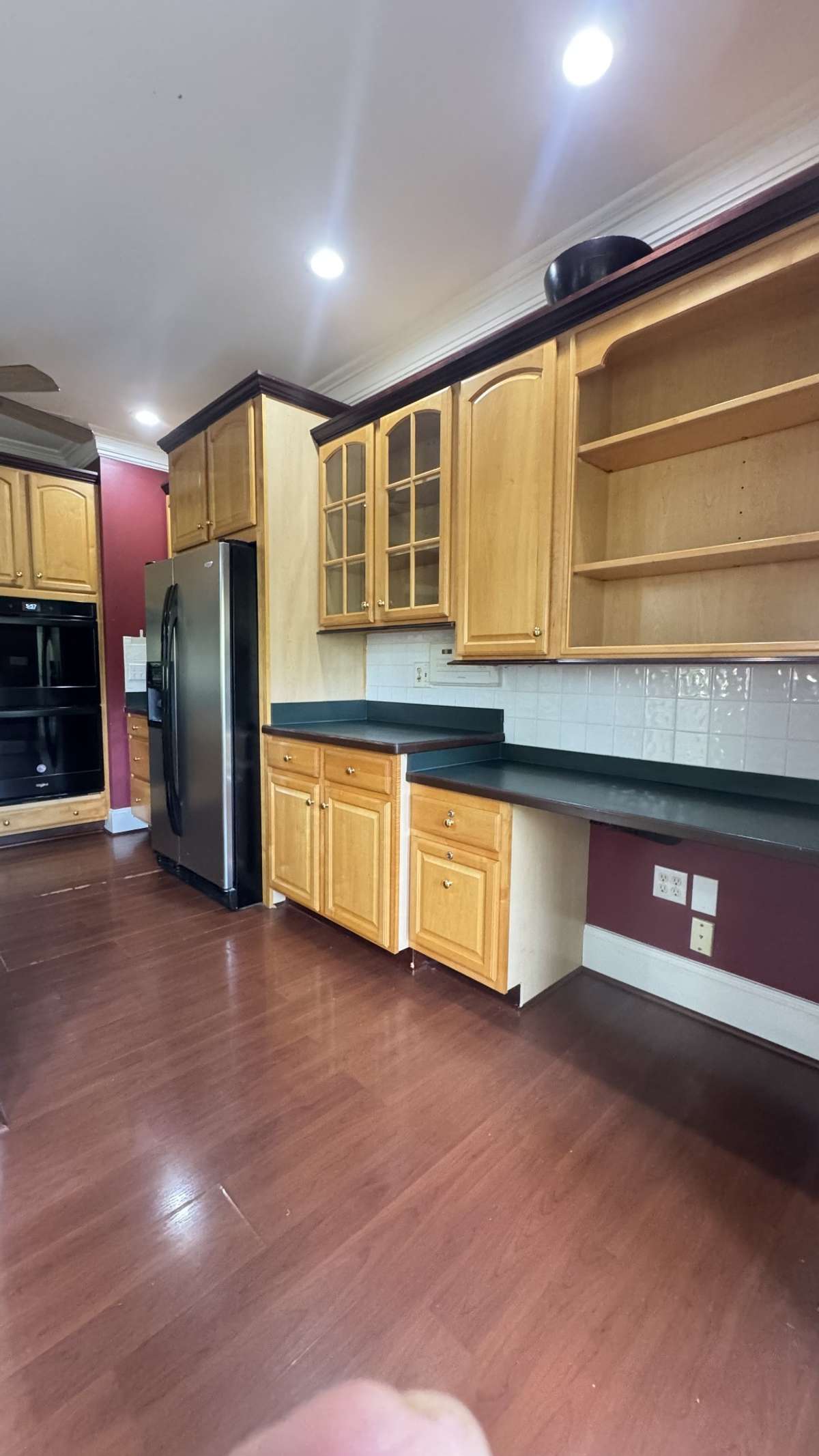 Kitchen is comlete with cabinets, office area, shelves and lots of counter space.