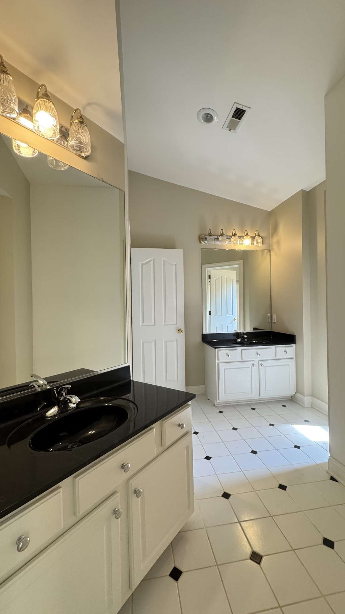 This is the other upstairs bath. Complete with two vanity areasmand a separate bathing area.