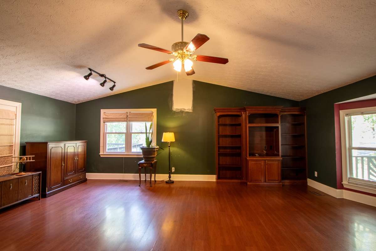 Tall ceilings, lots of windows, ceiling fan, additional lighting and a door out to the deck.