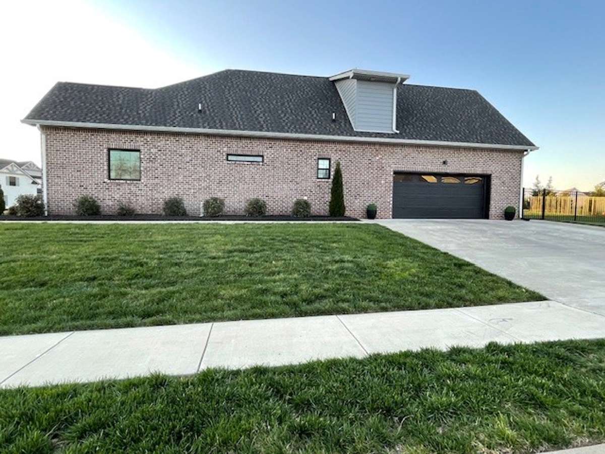 Right side of home Home shows home is all Brick with Big two car garage. Also Seller has installed a Rod Iron fence around back yard