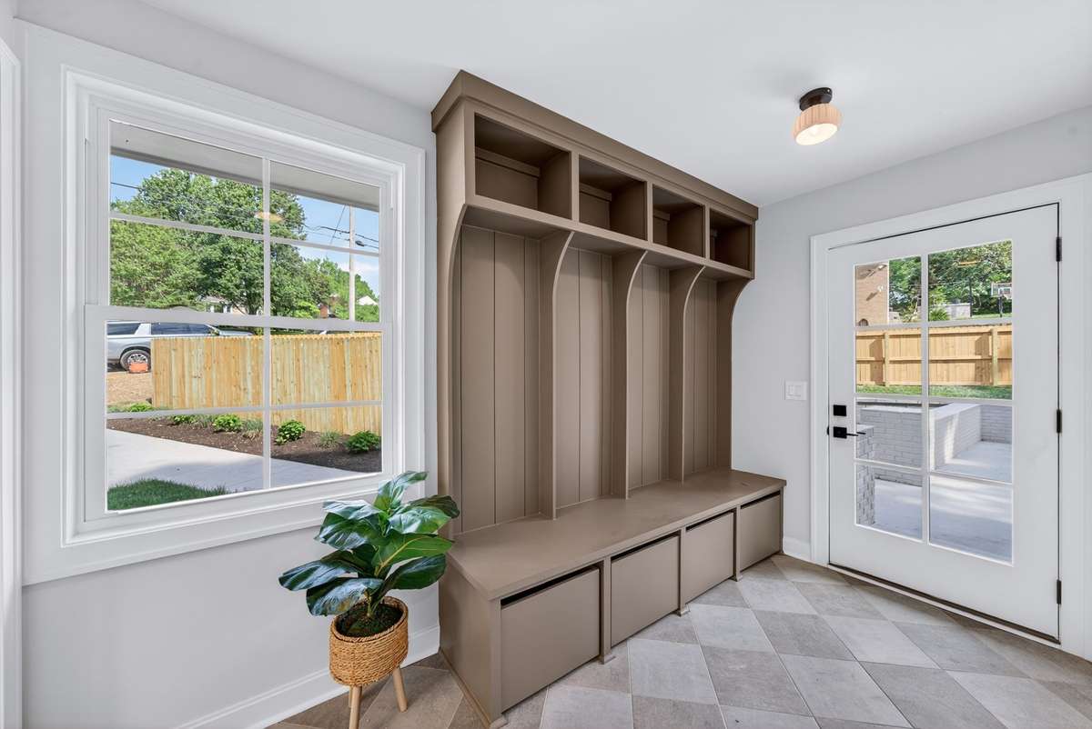 Built-in cubbies in the mudroom create a convenient and organized drop zone.