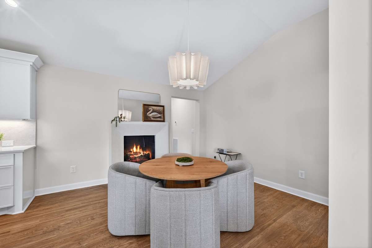 The dining area is highlighted by a fireplace with an ArcusStone surround.