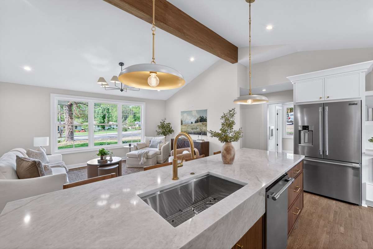 The vaulted ceilings and natural light create a bright, open space for the kitchen and living areas.