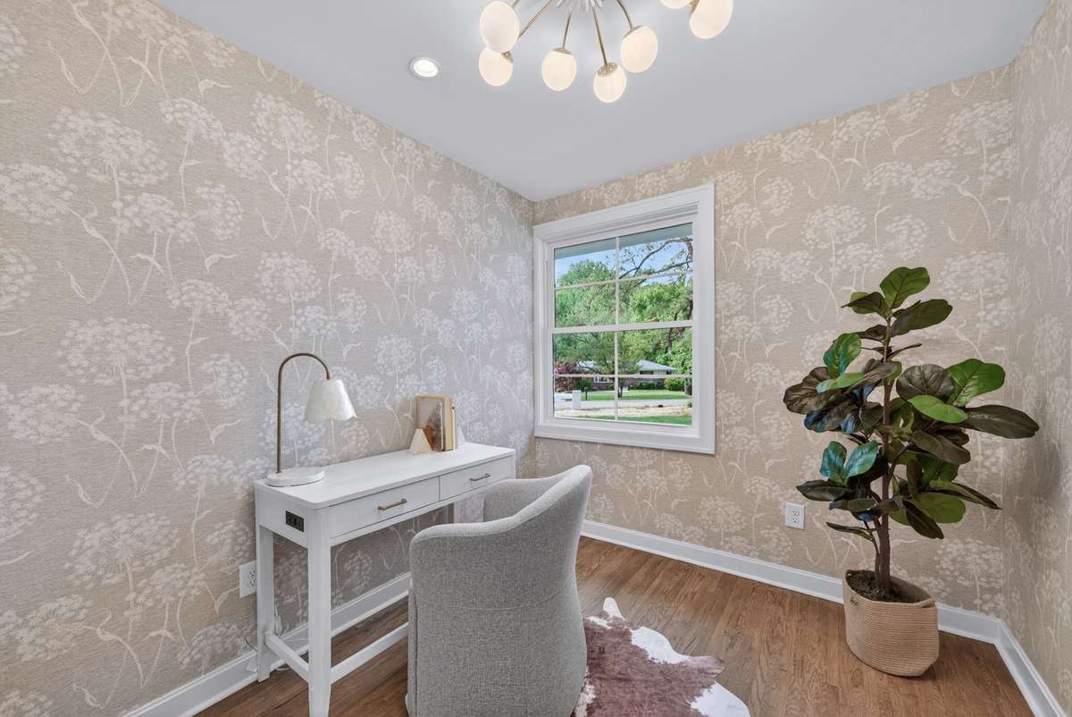 Designed for today's lifestyle, the home features a dedicated office, thoughtfully curated with beautiful wallpaper and lighting.