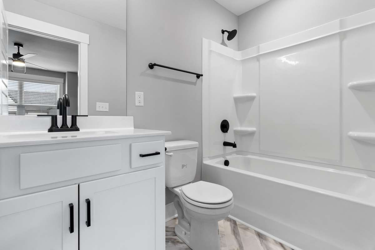 Attached bath features gorgeous tile flooring & upgraded fixtures!