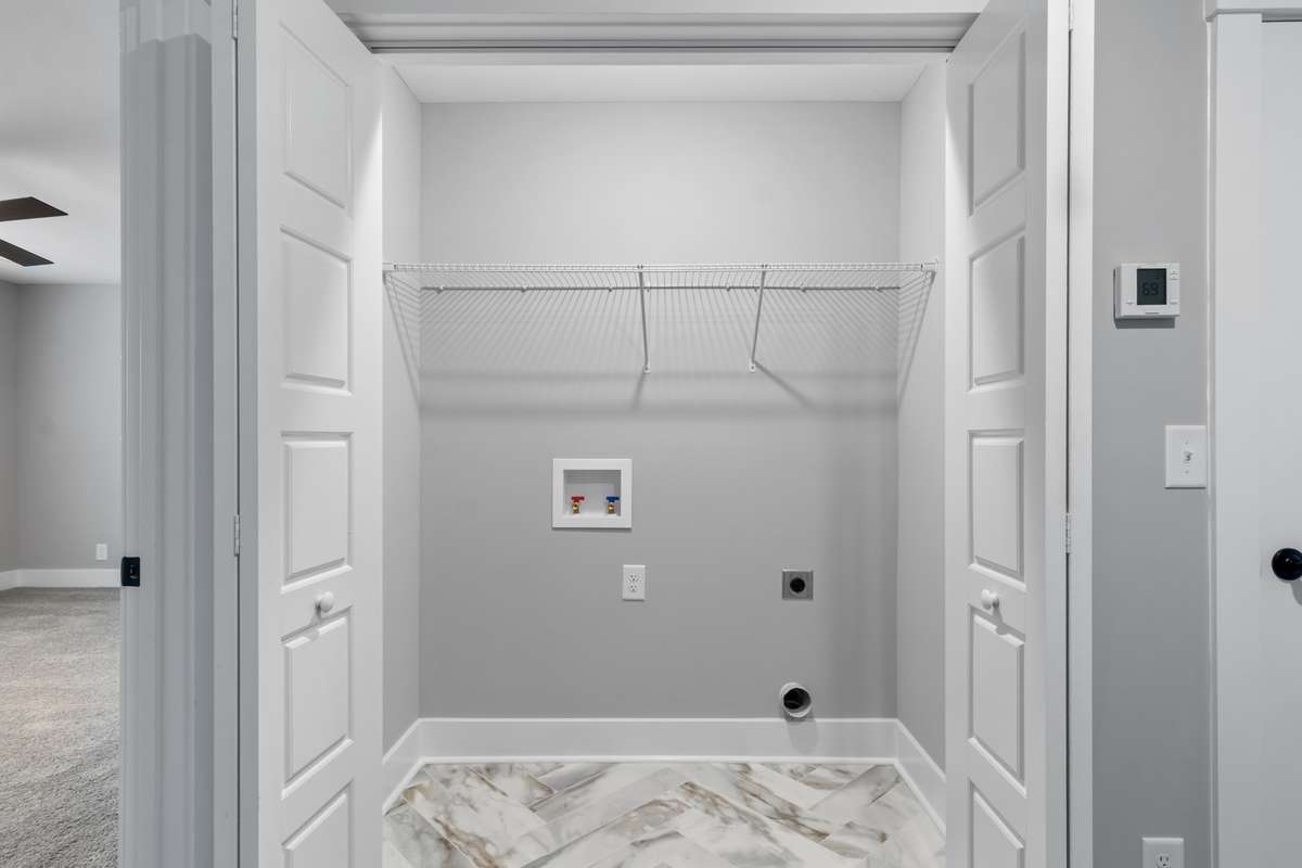 Laundry room is conveniently located upstairs between the bedrooms & includes gorgeous tile flooring.