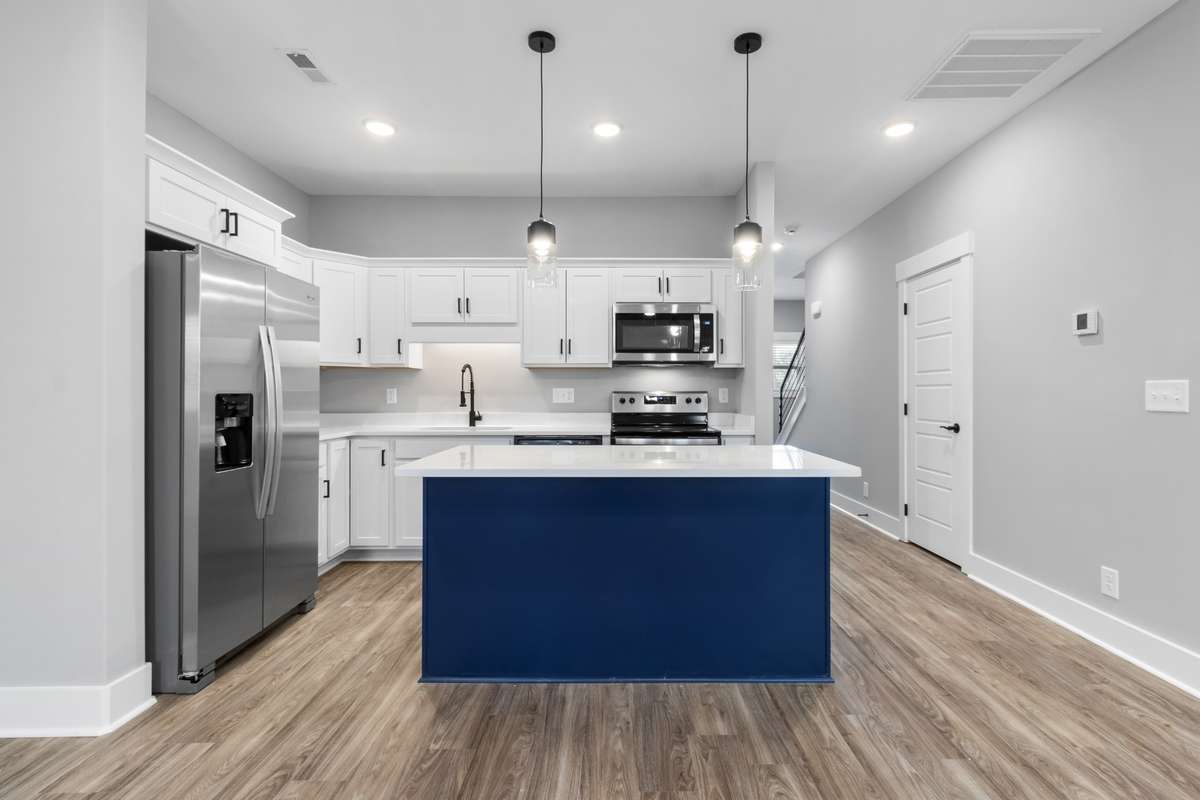 Kitchen also features quartz counters, stainless steel appliances, & upgraded fixtures.