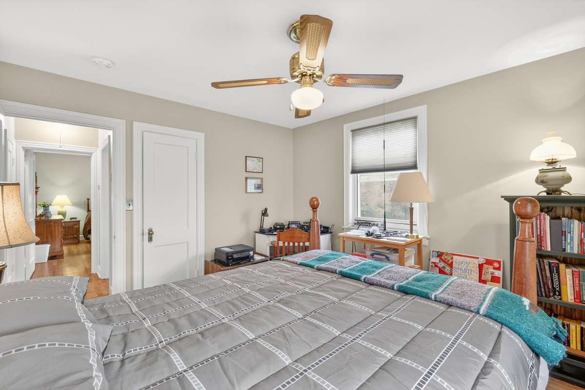 Bedroom #2 with neutral paint and closet.