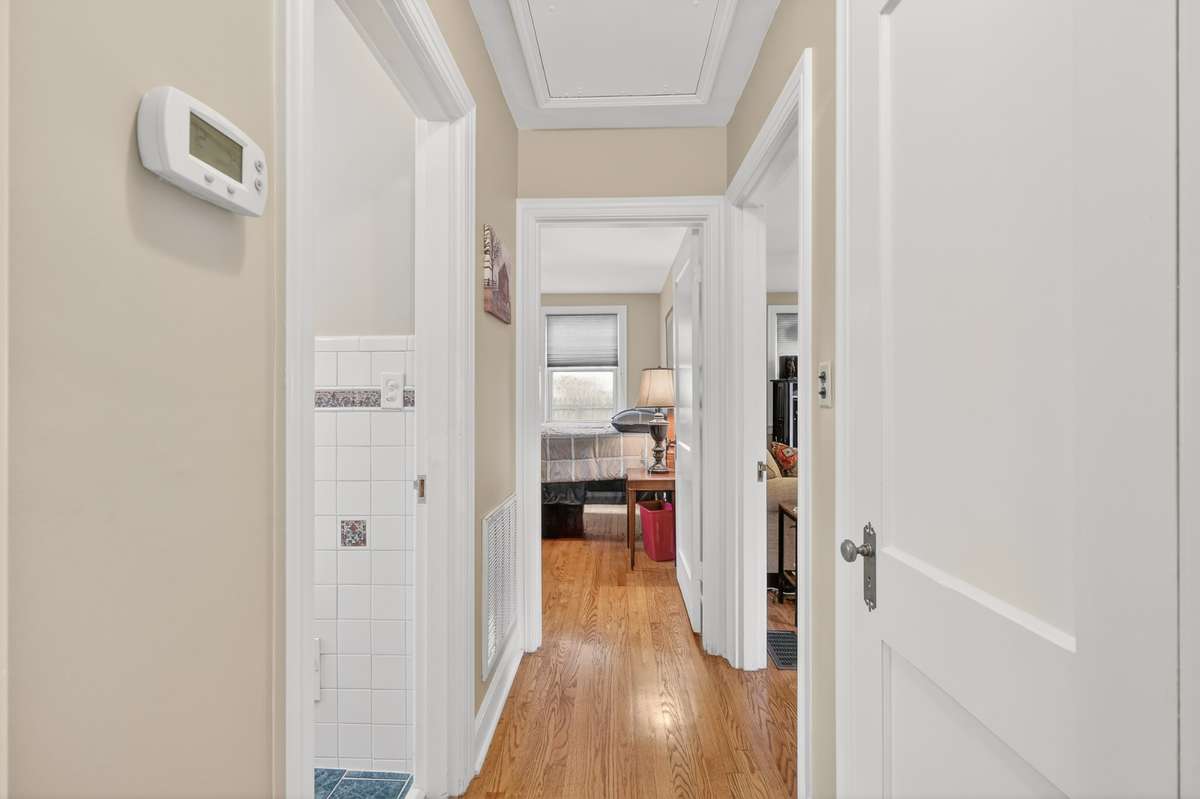 Main hallway with attic access and closet for extras!