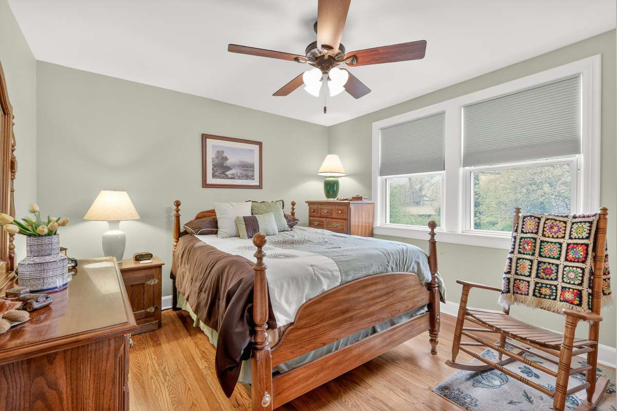 Owner's bedroom with neutral paint and custom shades.
