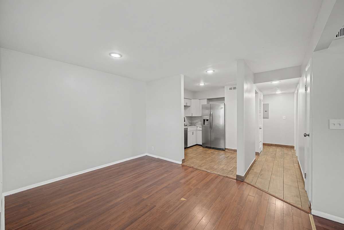 Hallway leads to two bedrooms and the full bathroom
