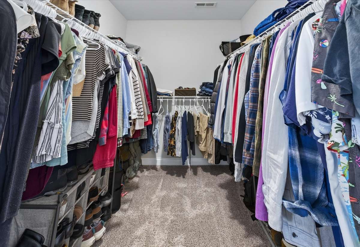 Primary bedroom walk in closet