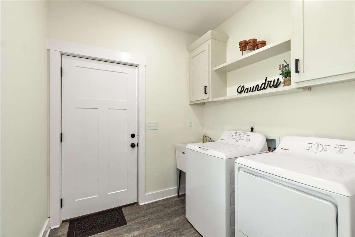This is the Utility Room with Cabinets, shelving, sink, washer, and dryer.  The door goes out into the garage area.