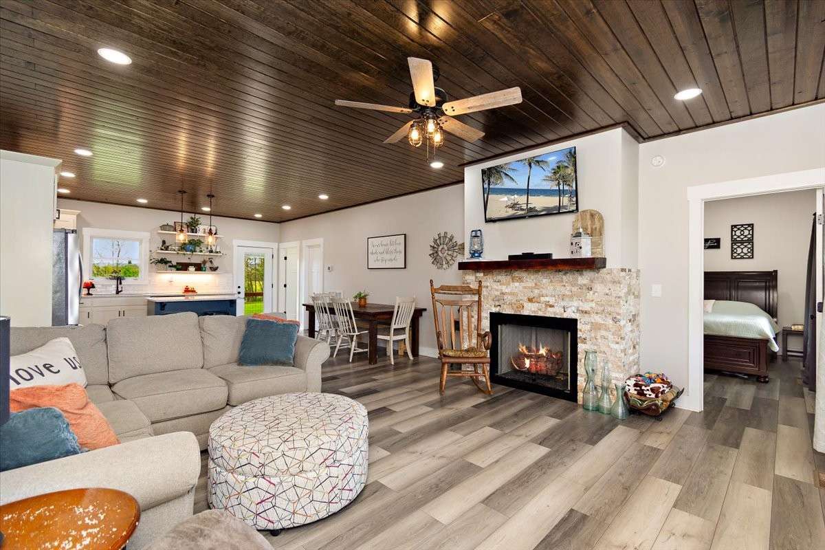 Here is another view of the open area.   It is very warm and inviting with the cozy fireplace, higher ceilings with wood, recessed lighting and so much more.