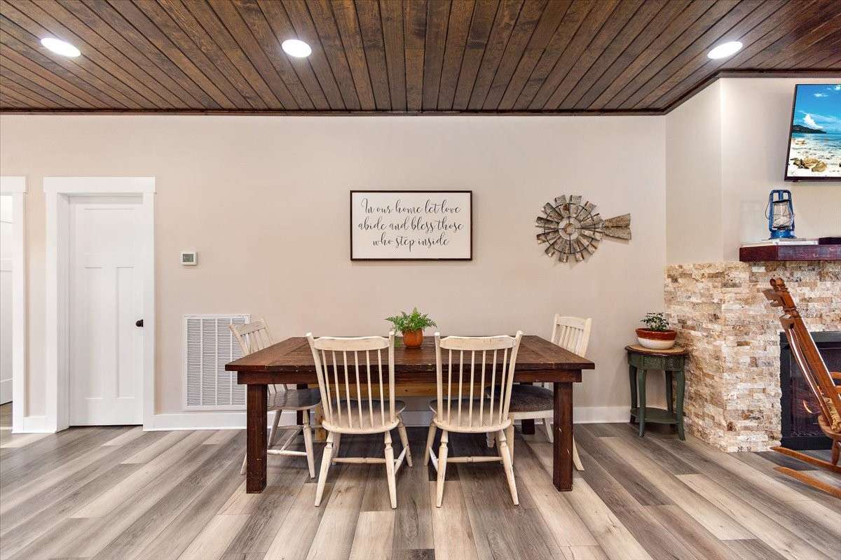 This is the Dining area which has the table pushed up against the wall to save space.
But it can be more centered if you want to sit behind the table also.