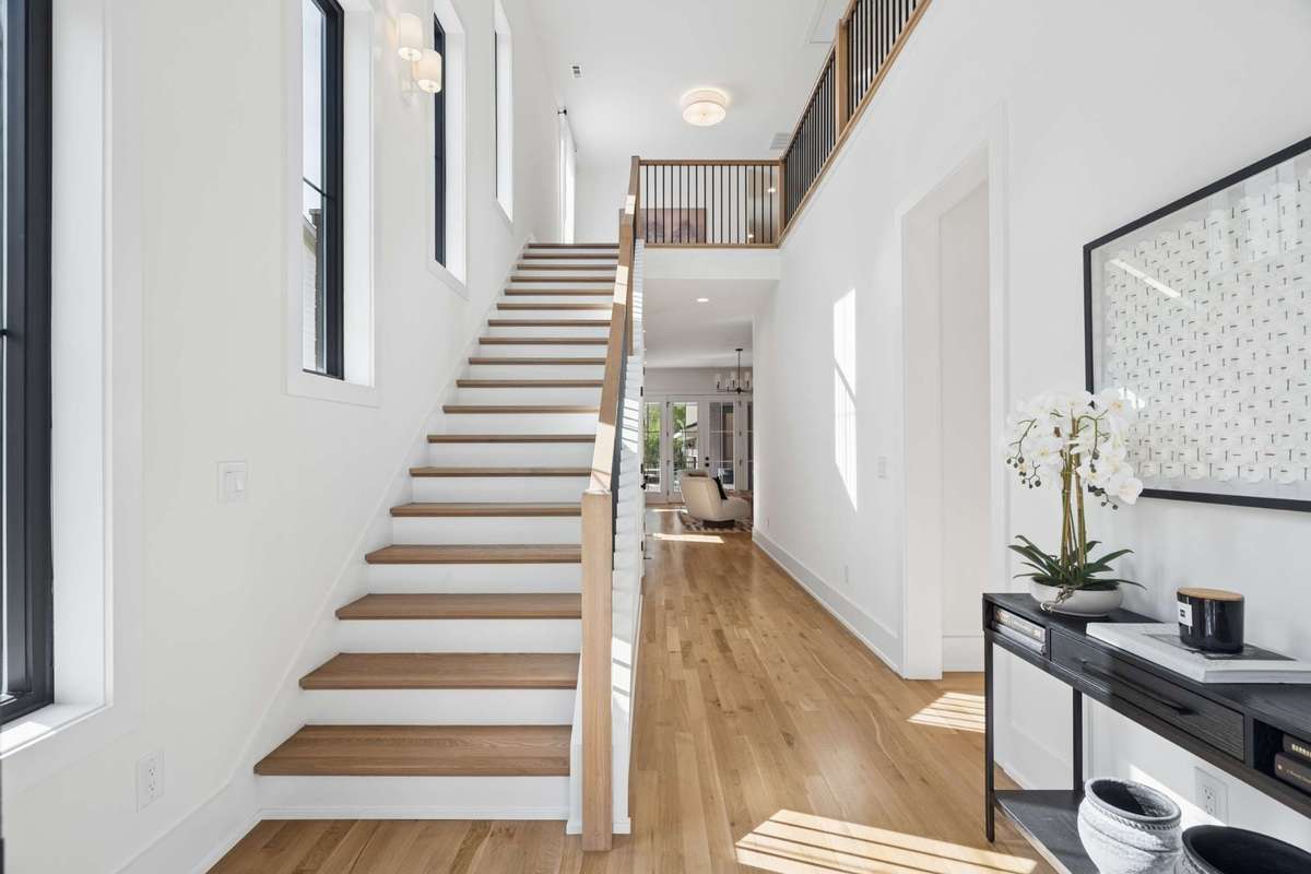 Step into a welcoming grand entrance featuring impressive 20-foot ceilings