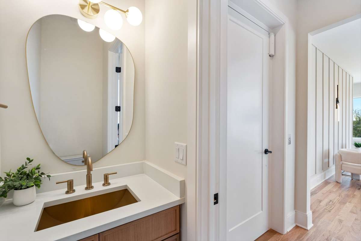 Guest powder room with champagne gold sink and faucet.