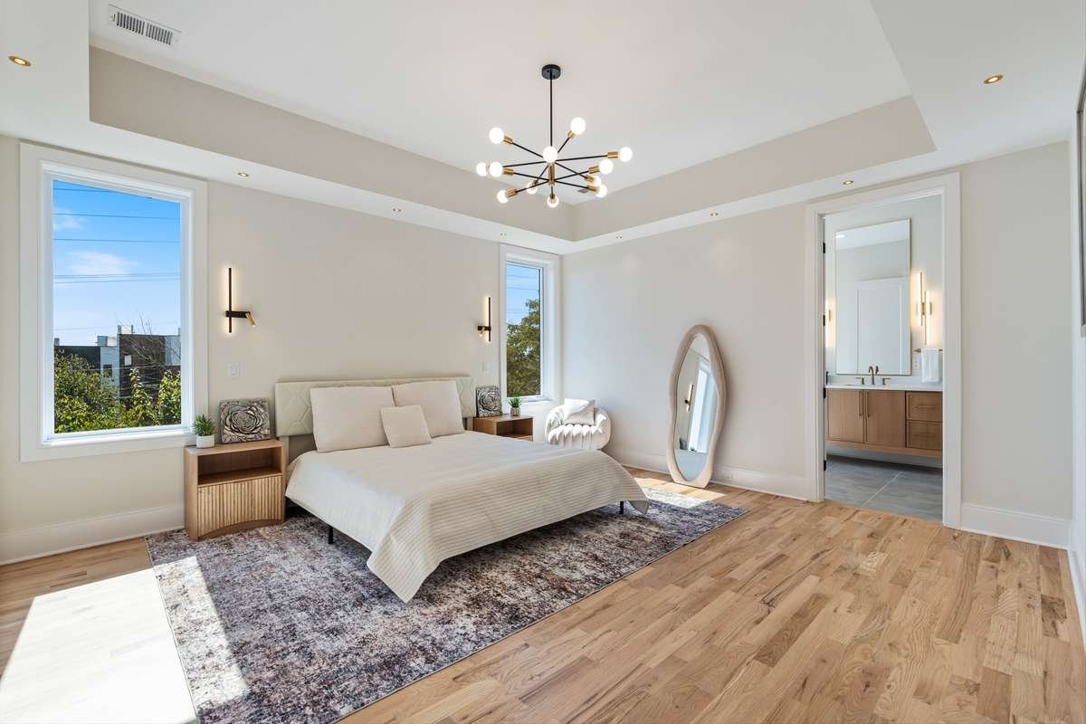 Primary with 2" can lights and wall sconce for reading and night light.
