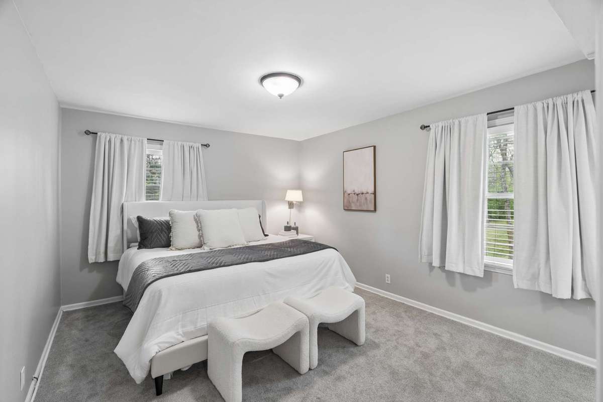 The primary bedroom is located at the back of the home and feels like a private retreat.