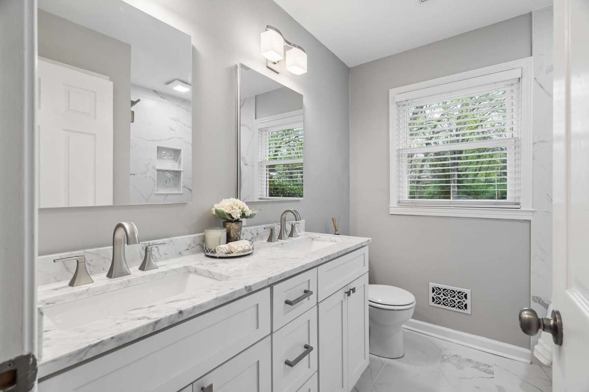 Renovated hall bathroom with dual vanities