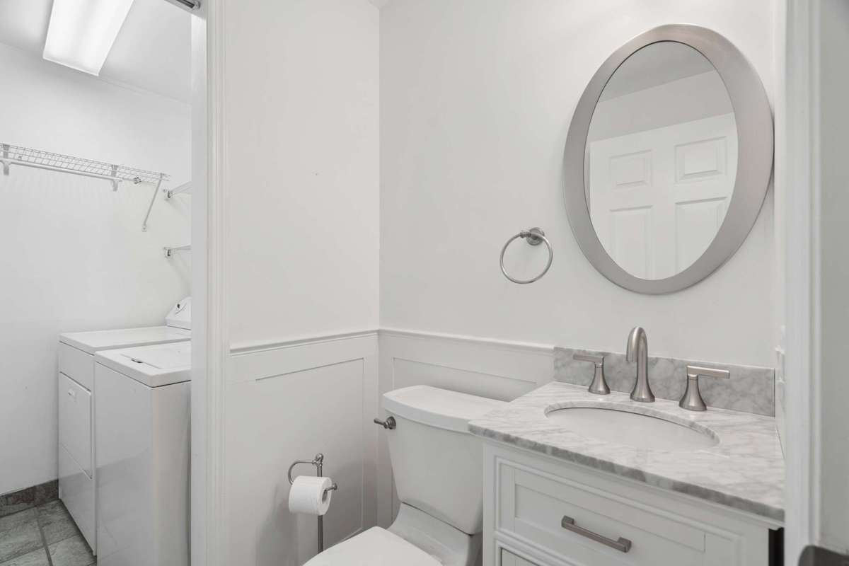 Half bath and laundry area in between the flex room and the kitchen