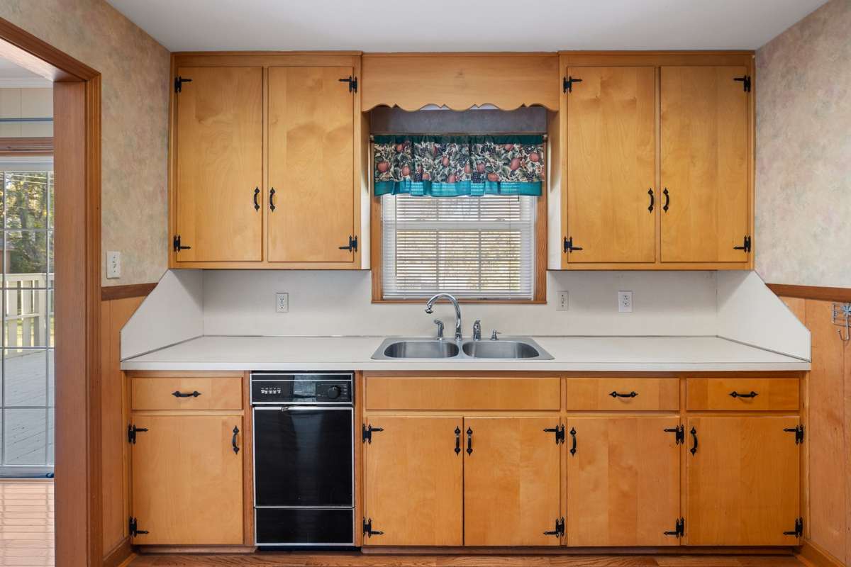 Loads of cabinets and wood floors in kitchen and throughout the home