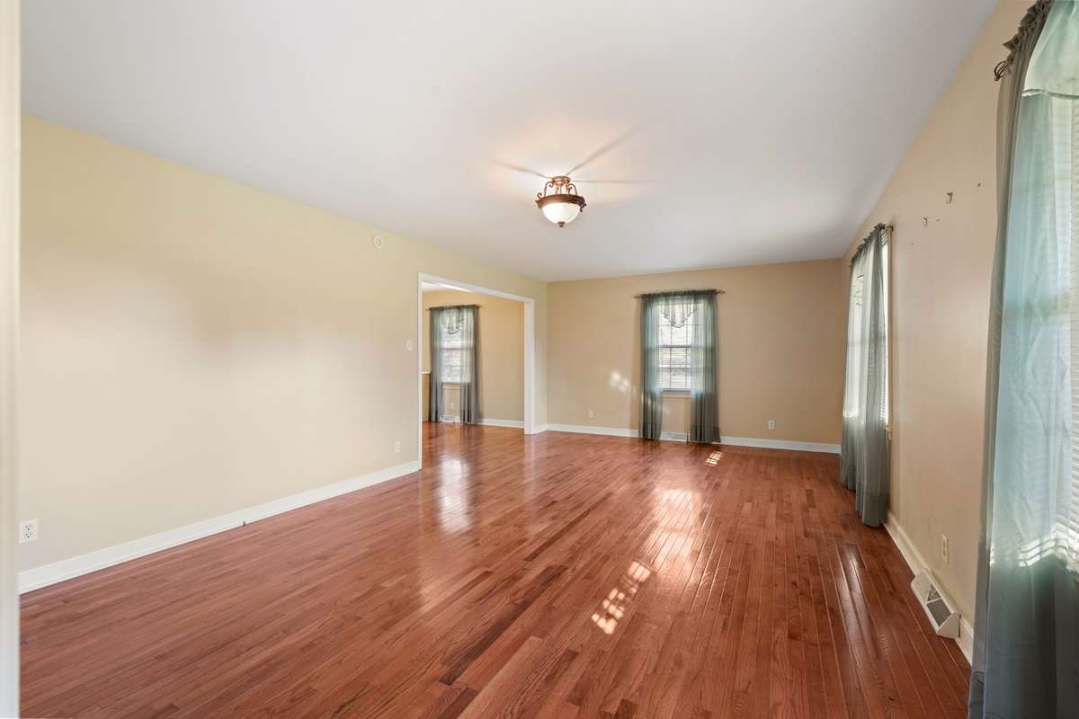 Another view of Living Room and wood Floors with lots of windows