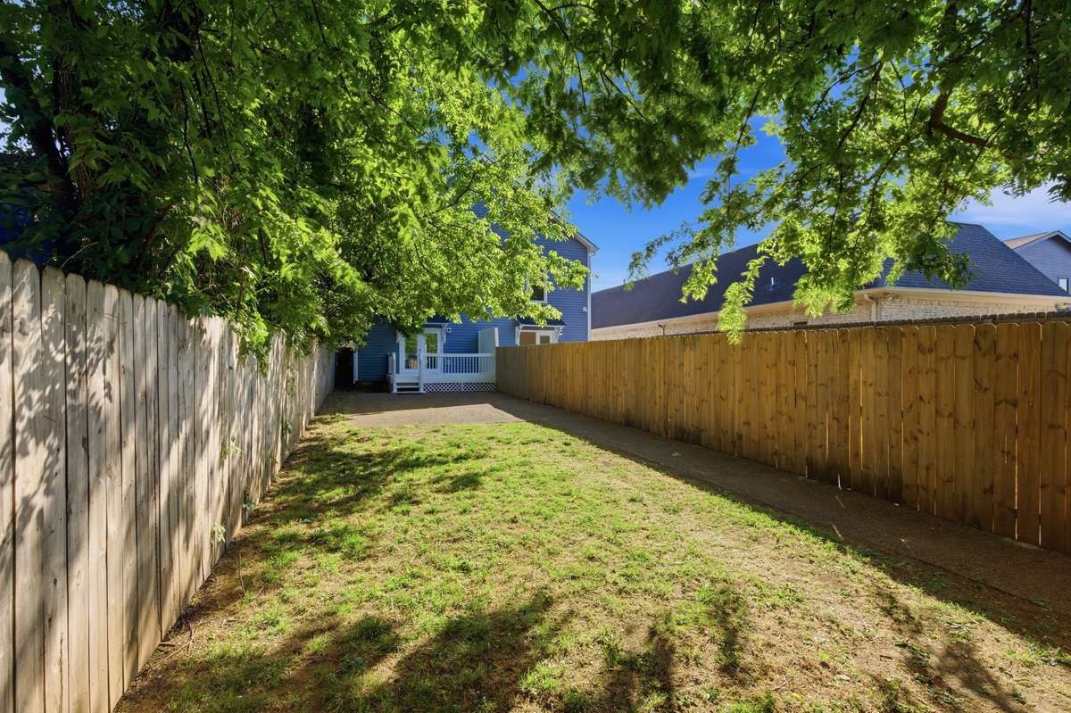 Expansive, fully-fenced and private back yard with alley access through the wide vehicle gate.