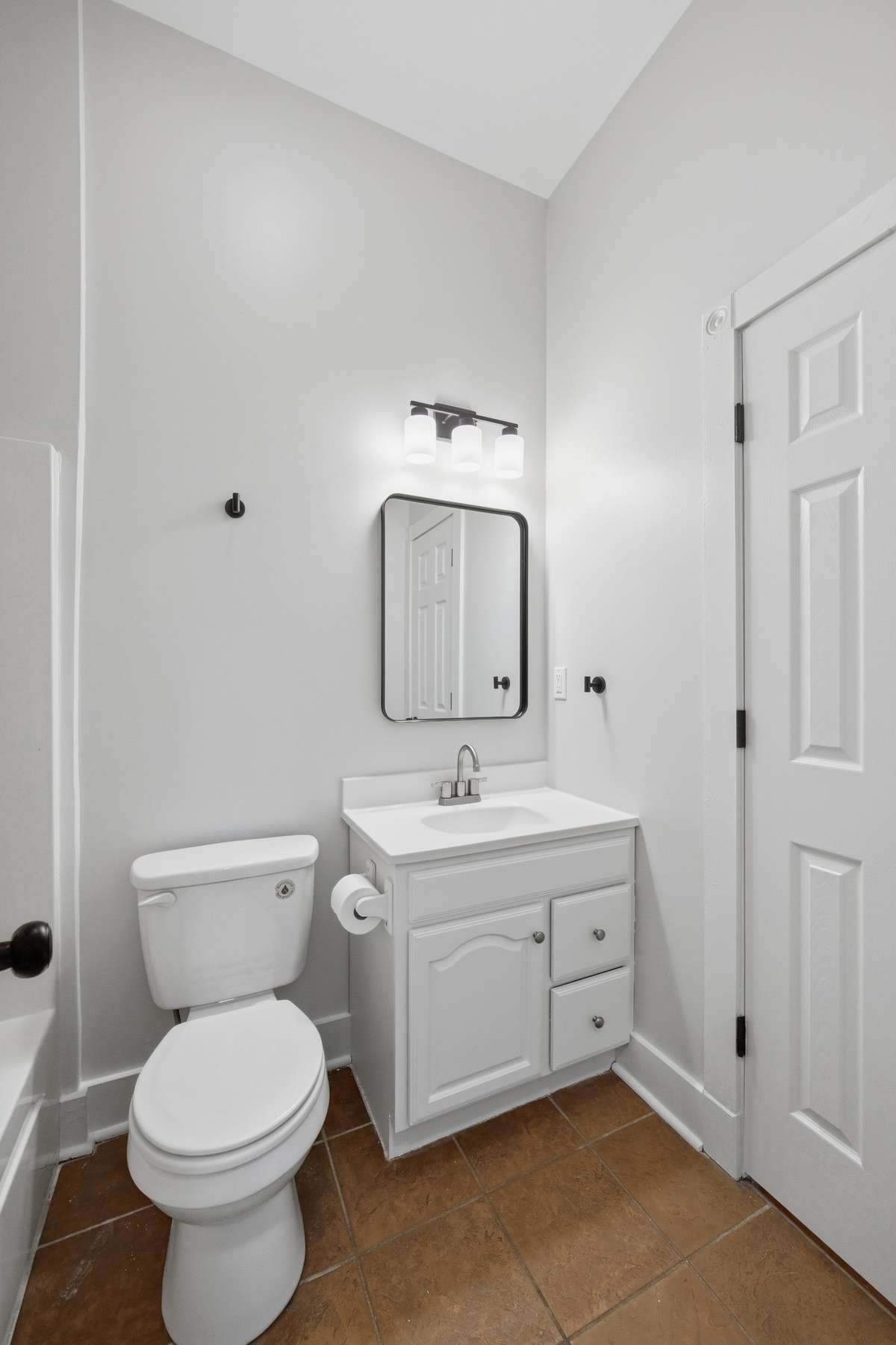Full bathroom (tub/shower combo out of frame to the left) on the main floor. There is access to this bathroom from the hallway and main level bedroom.