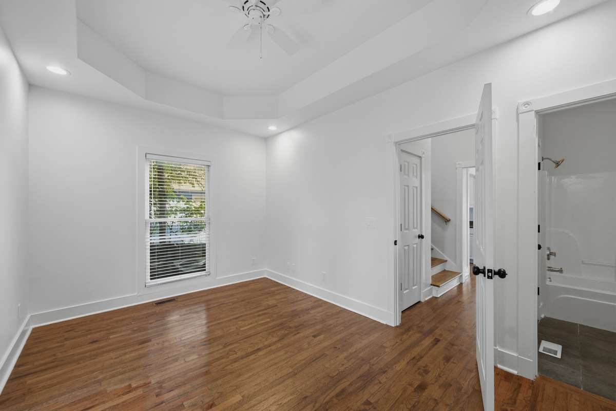 This bedroom on the main floor could also be used as an office or some other kind of flex space; there are two closets out of frame to the right, as well as direct access to the full bathroom.