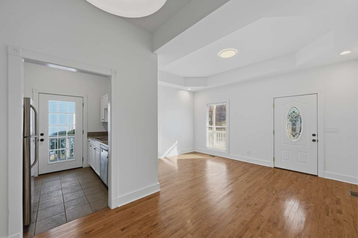 A view from the dining area looking towards the living room and into the kitchen.