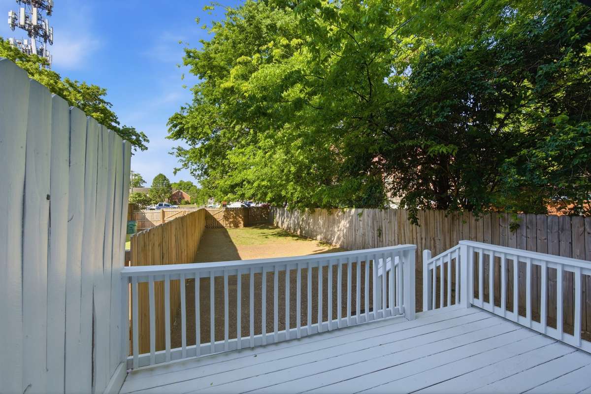 This is a rarity so close to downtown Nashville: a private deck and deep back yard with grass, a parking pad, and gate to pull your vehicle(s) through.