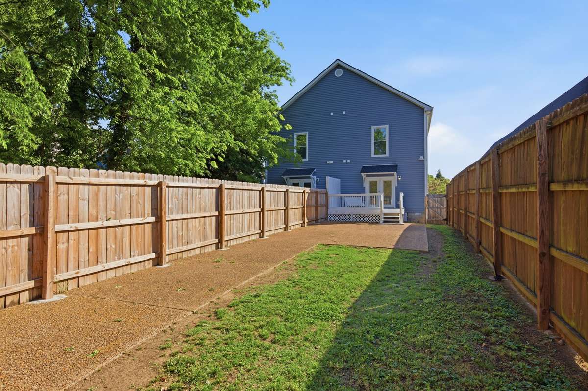 Expansive, fully-fenced and private back yard with alley access through the wide vehicle gate.