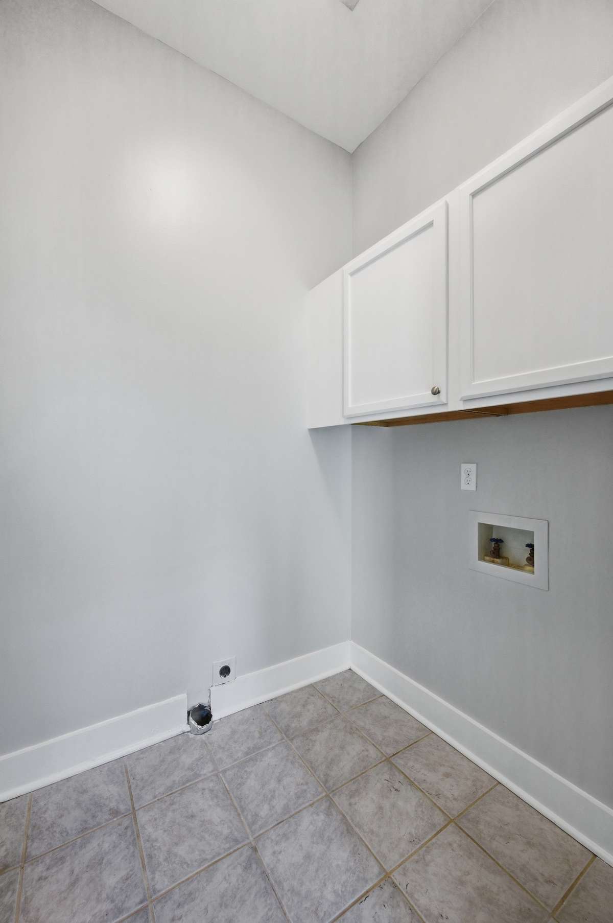 The laundry room is conveniently located on the second floor between the two upstairs bedrooms. Notice the additional cabinet storage.