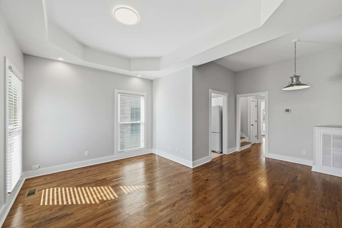 Just inside the front door, you are greeted with tall ceilings, tons of natural light, and real hardwood floors.