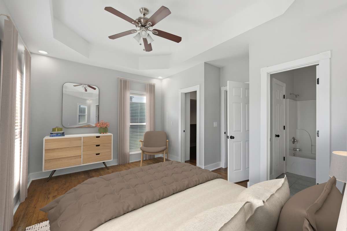 Another view of the primary bedroom. The far door leads to a large walk-in closet and the door on the right leads to the full bathroom. Virtually staged.