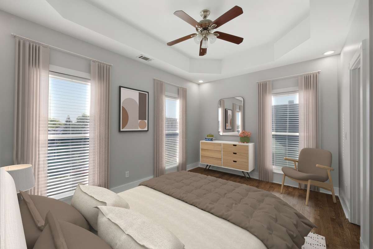 The primary bedroom on the second floor. Big windows, great natural light, and plenty of room for your king bed and furniture. Also notice the 9 foot ceilings on the second floor as well. Virtually staged.