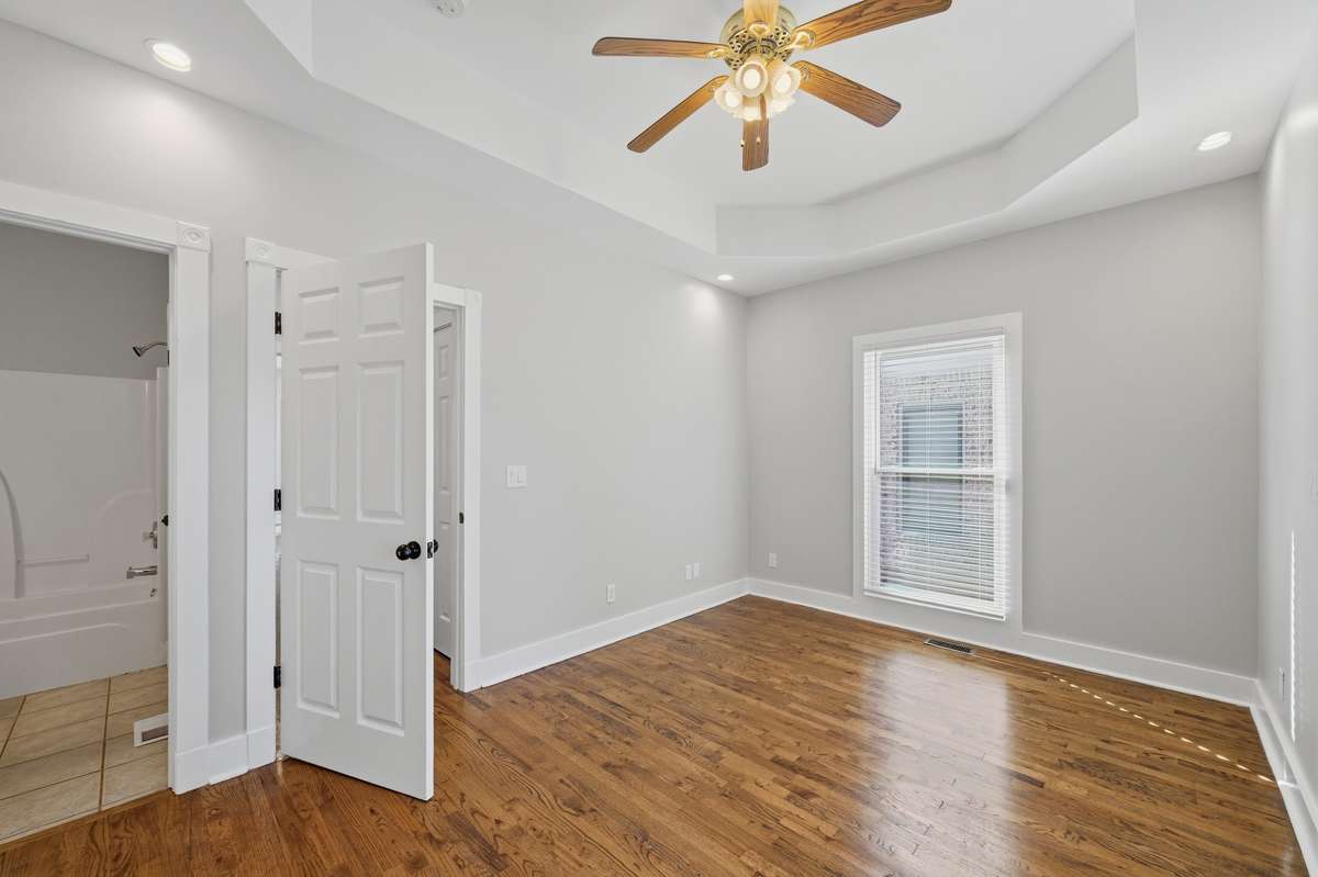 This bedroom on the main floor could also be used as an office or some other kind of flex space; there are two closets out of frame to the left, as well as direct access to the full bathroom.