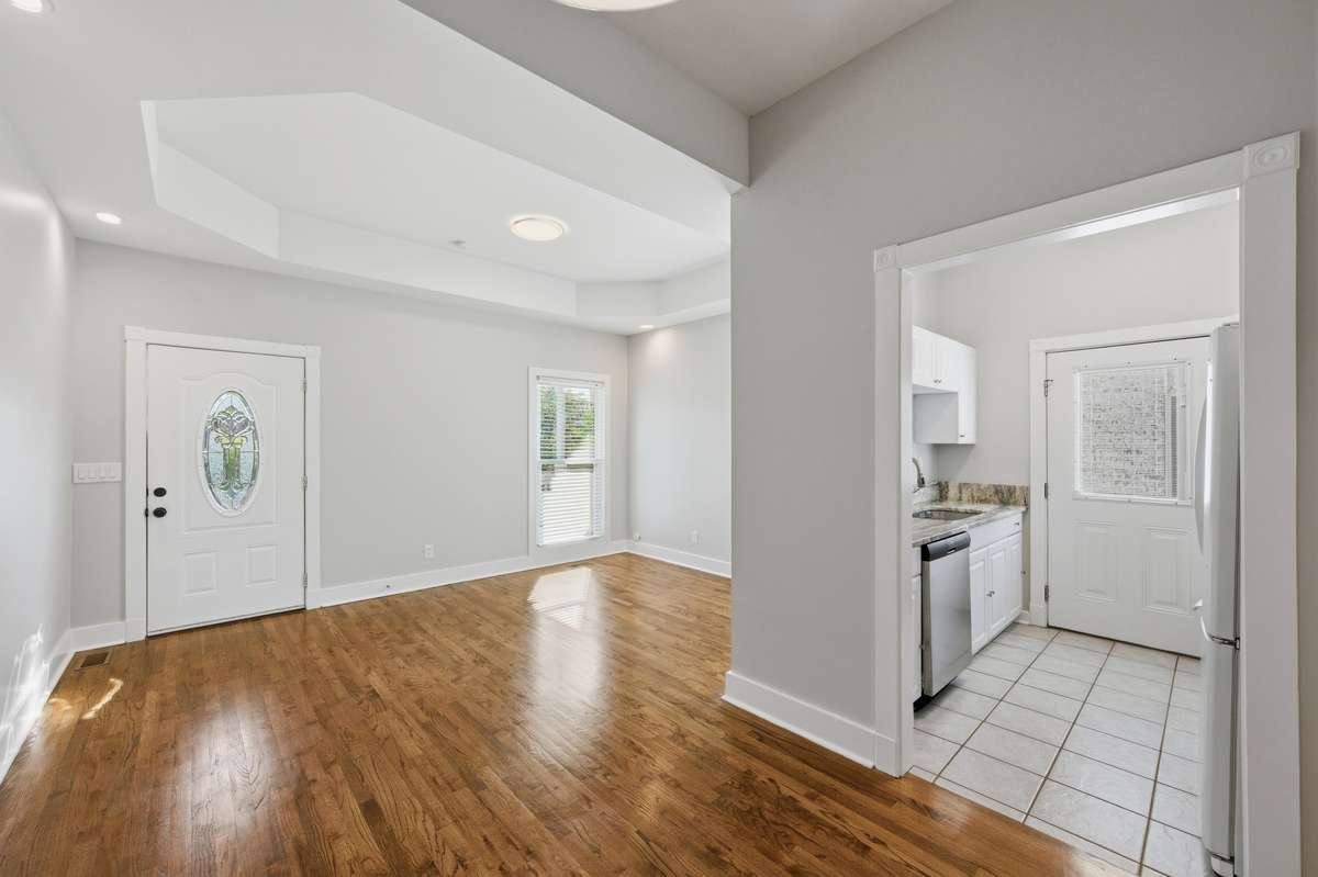 A view from the dining area looking towards the living room and into the kitchen.