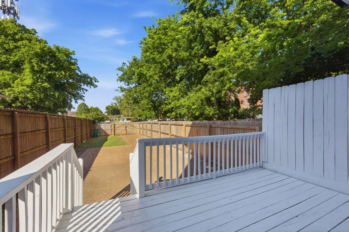 This is a rarity so close to downtown Nashville: a private deck and deep back yard with grass, a parking pad, and gate to pull your cars through.