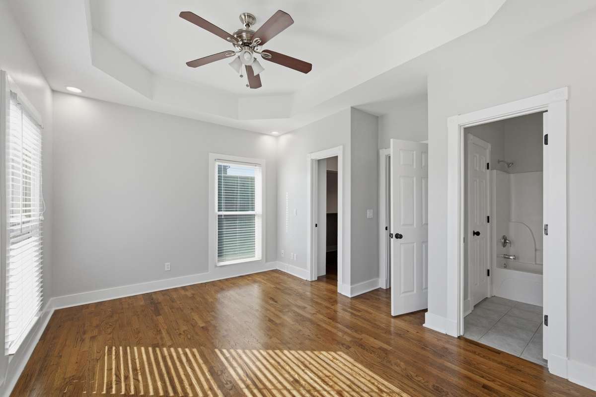 Another view of the primary bedroom. The far door leads to a large walk-in closet and the door on the right leads to the full bathroom.