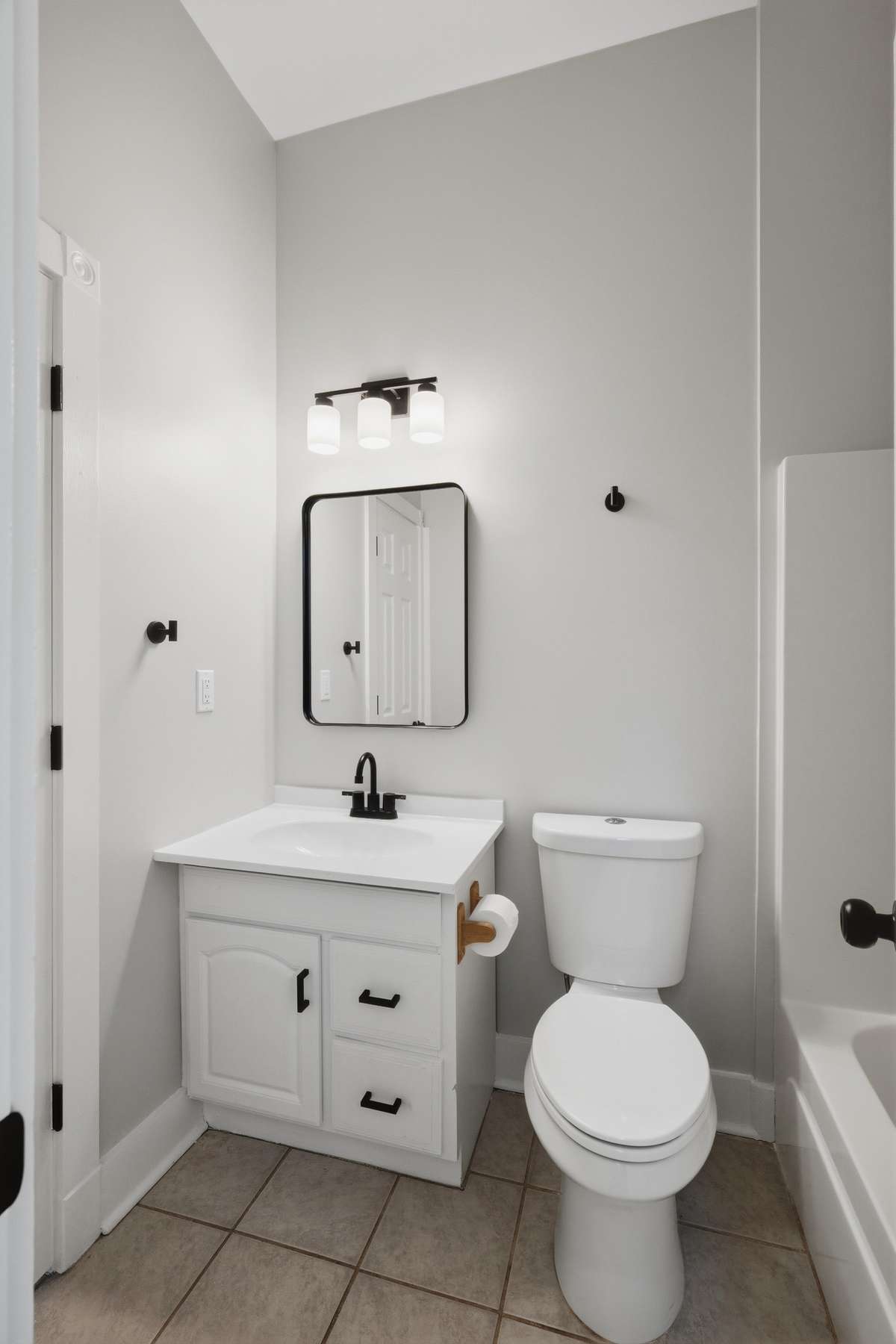 Full bathroom (tub/shower combo out of frame to the right) on the main floor. There is access to this bathroom from the hallway and main level bedroom.