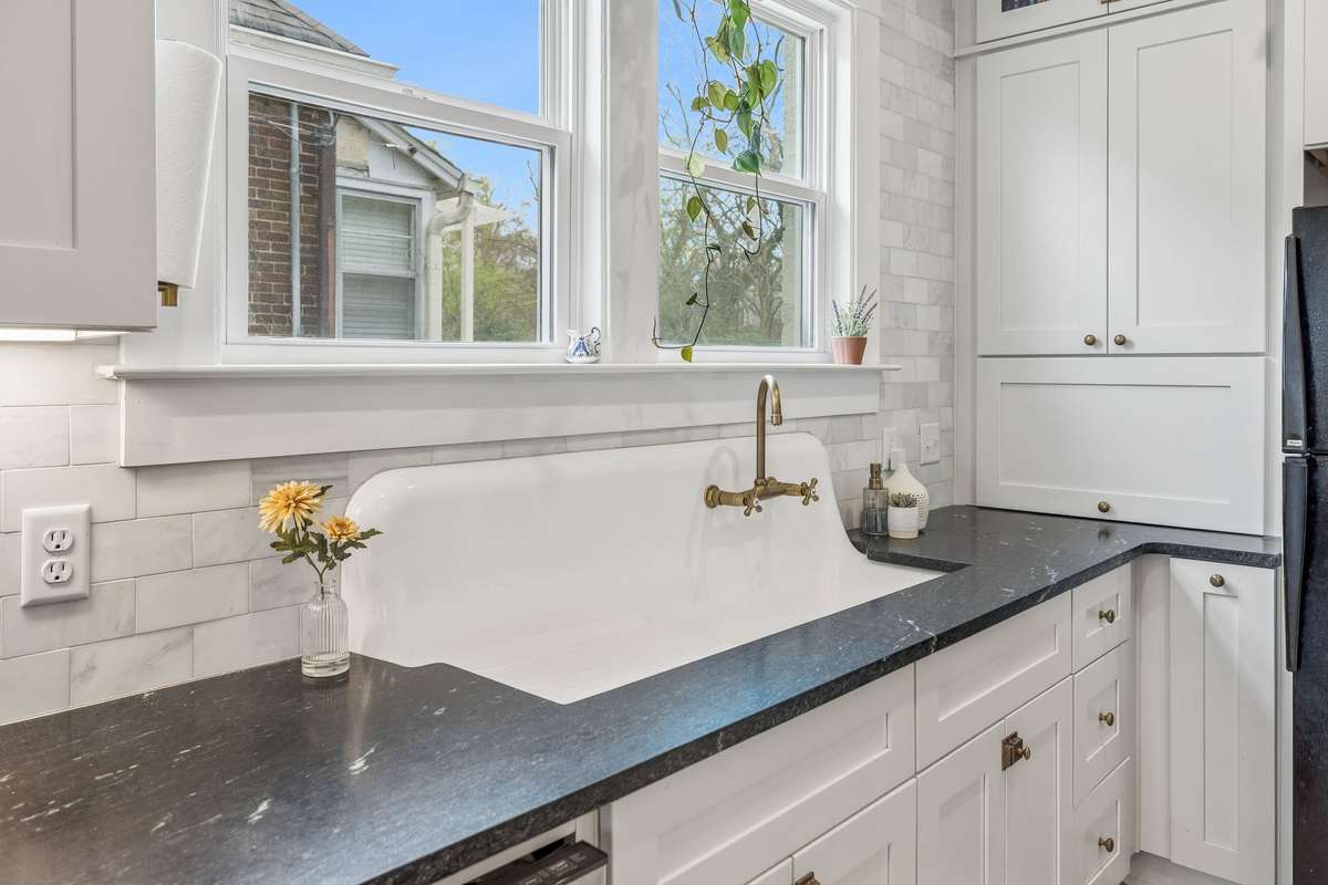 Large original cast iron sink with brass fixture