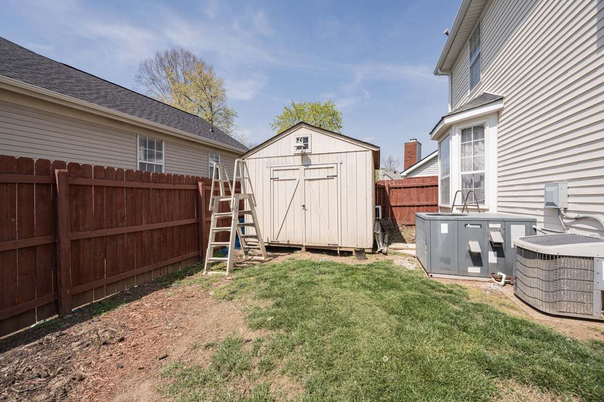 Home has storage building for additional storage along with 2 car garage