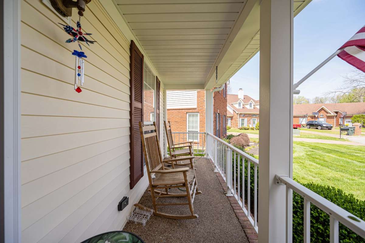 Nice rocking chair front porch overlooking a beautiful lawn