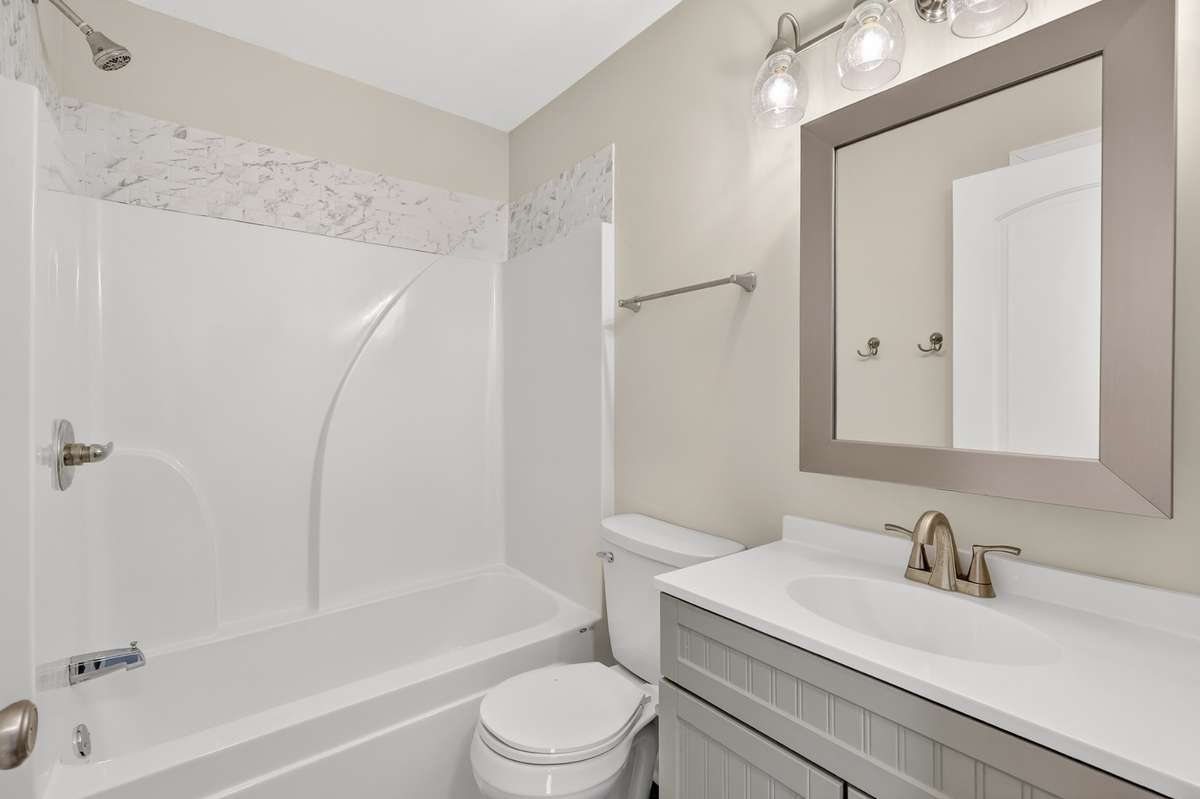 The full bath is very clean and has space for everyone. The custom mirror adds style!