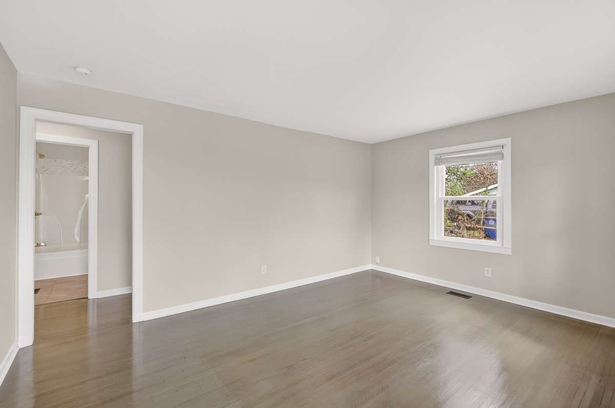 The living room has space for your furniture and is separate from kitchen area